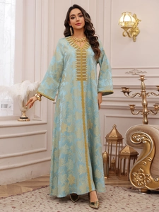 Detailed view of light blue Kaftan with gold leaf jacquard and intricate embroidery