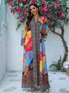 Detail of bohemian long sleeve kaftan dress with geometric print and floral patterns