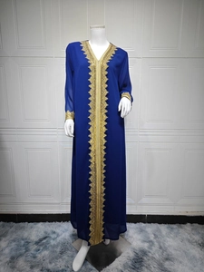 Detail of royal blue chiffon dress featuring intricate golden embroidery on V-neck and sleeves