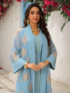 Detailed gold palm leaf embroidery on light blue open-front kaftan and inner dress
