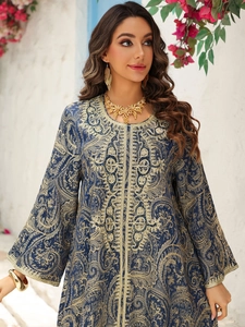 Close-up of golden paisley embroidery and beaded details on a navy evening kaftan dress