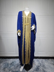 Detail of royal blue chiffon caftan featuring golden lace embroidery and braided belt