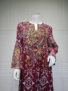 Detail of burgundy embroidered mesh maxi dress with sequins and geometric patterns