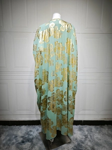 Detailed close-up of mint green kaftan with luxury gold metallic floral patterns