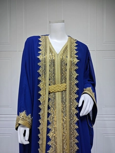 Detailed view of dark blue chiffon kaftan dress with golden embroidery and braided belt