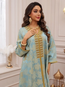 Detailed embroidery and sequins on light blue Kaftan dress with golden leaf patterns