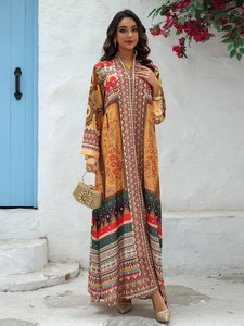 Detail view of ethnic print kaftan dress featuring a deep V-neck and ornate embroidery