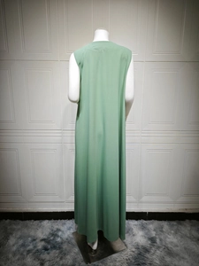 Rear view of a sage green sleeveless maxi dress with minimalist A-line flowing silhouette