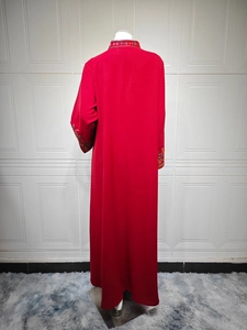 Detail of red floor-length dress featuring ethnic floral embroidery on sleeves and back