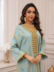 Detail of light blue Kaftan with gold leaf jacquard and intricate beaded embroidery