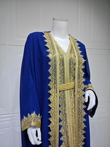 Detailed view of dark blue chiffon kaftan with gold lace embroidery and woven belt accessory