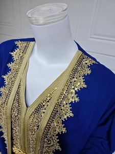 Detailed view of intricate gold embroidery and sequins on a navy blue chiffon dress