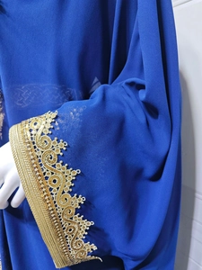 Close-up of royal blue chiffon sleeve with intricate gold embroidery and sequins
