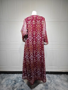 Detail view of the back of a wine red bohemian maxi dress with geometric embroidery patterns