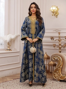 Detail of navy blue dress featuring intricate gold leaf jacquard and sequin embroidery