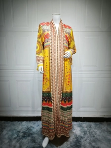Detailed view of yellow ethnic print maxi dress with floral patterns and chiffon texture