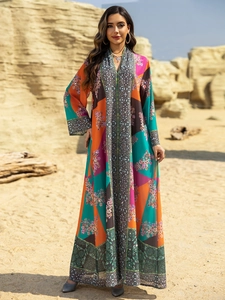 Detailed close-up of a long-sleeved boho dress featuring colorful geometric floral prints