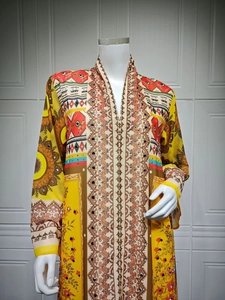 Detailed view of yellow ethnic print chiffon dress with V-neck and intricate patterns