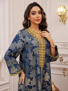 Close-up of navy blue Kaftan dress with gold leaf embroidery and beaded neckline detail