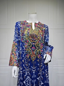 Detail of colorful ethnic embroidery and sequins on navy mesh long sleeve dress