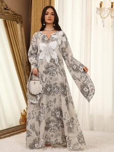 Detail of elegant V-neck dress with floral prints and intricate sequin flower embroidery