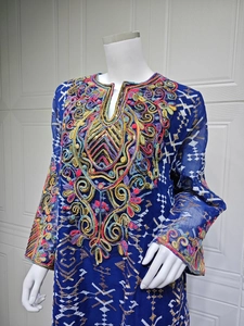 Detail of royal blue dress featuring vibrant ethnic floral embroidery and sequins