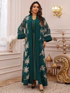 Detail of dark green abaya with gold palm embroidery and elegant sheer chiffon fabric