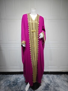Detail of elegant gold lace embroidery on fuchsia chiffon kaftan with matching belt