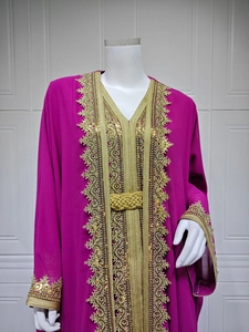 Detail of gold embroidery and sequin trim on a purple Moroccan chiffon kaftan dress