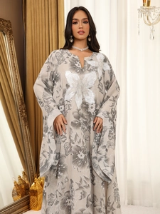 Detail of floral embroidery and sequins on a beige long-sleeve caftan dress