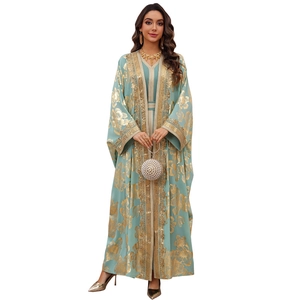 Mint green two-piece kaftan dress with gold floral patterns and pearl evening bag