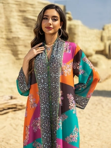 Detail of colorful V-neck kaftan maxi dress with floral print and rhinestone accents