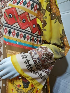 Detail of ethnic floral print on chiffon dress with sparkling rhinestone embellishments