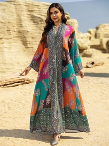 Close-up of ethnic kaftan dress with colorful patterns, V-neckline and sequin embroidery