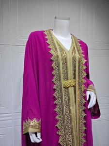 Detailed view of intricate gold embroidery and sequins on the purple kaftan dress