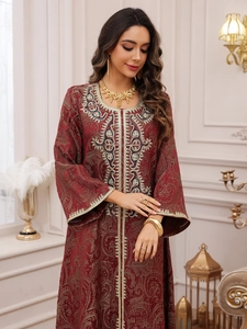 Detailed embroidery and jacquard texture on a luxury dark red Kaftan evening dress