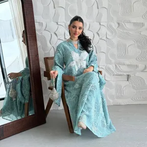 Detail of light blue embroidered caftan dress with white floral lace and sequins
