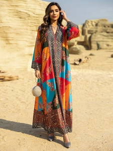 Detailed pattern of a vibrant bohemian kaftan dress with intricate floral prints and beadwork