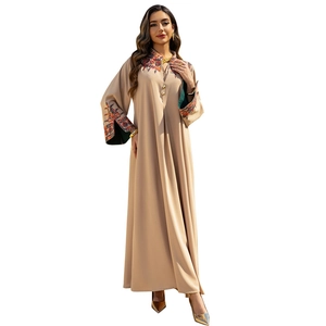 Elegant beige Abaya dress featuring intricate ethnic embroidery and green satin lining accents