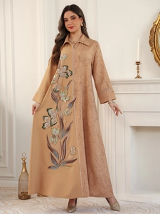 Detail of camel long dress featuring intricate floral embroidery and colorful sequins