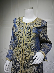 Detail of navy blue kaftan featuring gold floral embroidery and paisley jacquard pattern