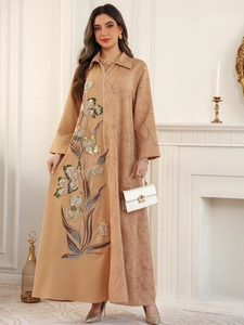 Detailed embroidery with gold and green sequins on camel jacquard patchwork dress
