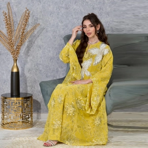 Detail of yellow floral dress with silver sequin embroidery and elegant flared sleeves