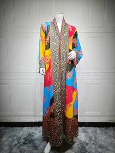 Detail of colorful floral patchwork pattern and ethnic trim on long Abaya dress