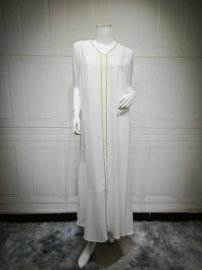 Detail of white sleeveless abaya dress with delicate gold trim on lightweight chiffon