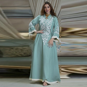 Mint green kaftan dress featuring white floral vine embroidery and long sleeves
