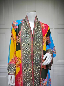 Detail of bohemian floral maxi dress featuring vibrant patterns and V-neckline on mannequin