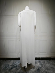 Rear view of long white sleeveless dress with a minimalist round neck and flowing hem
