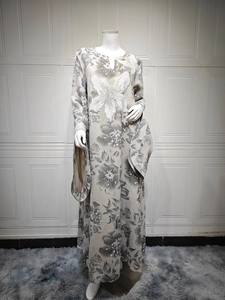 Detail of floral abaya with intricate white butterfly embroidery and beaded sequins