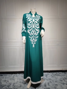 Detailed silver embroidery on the neckline and sleeves of the dark green ethnic long dress